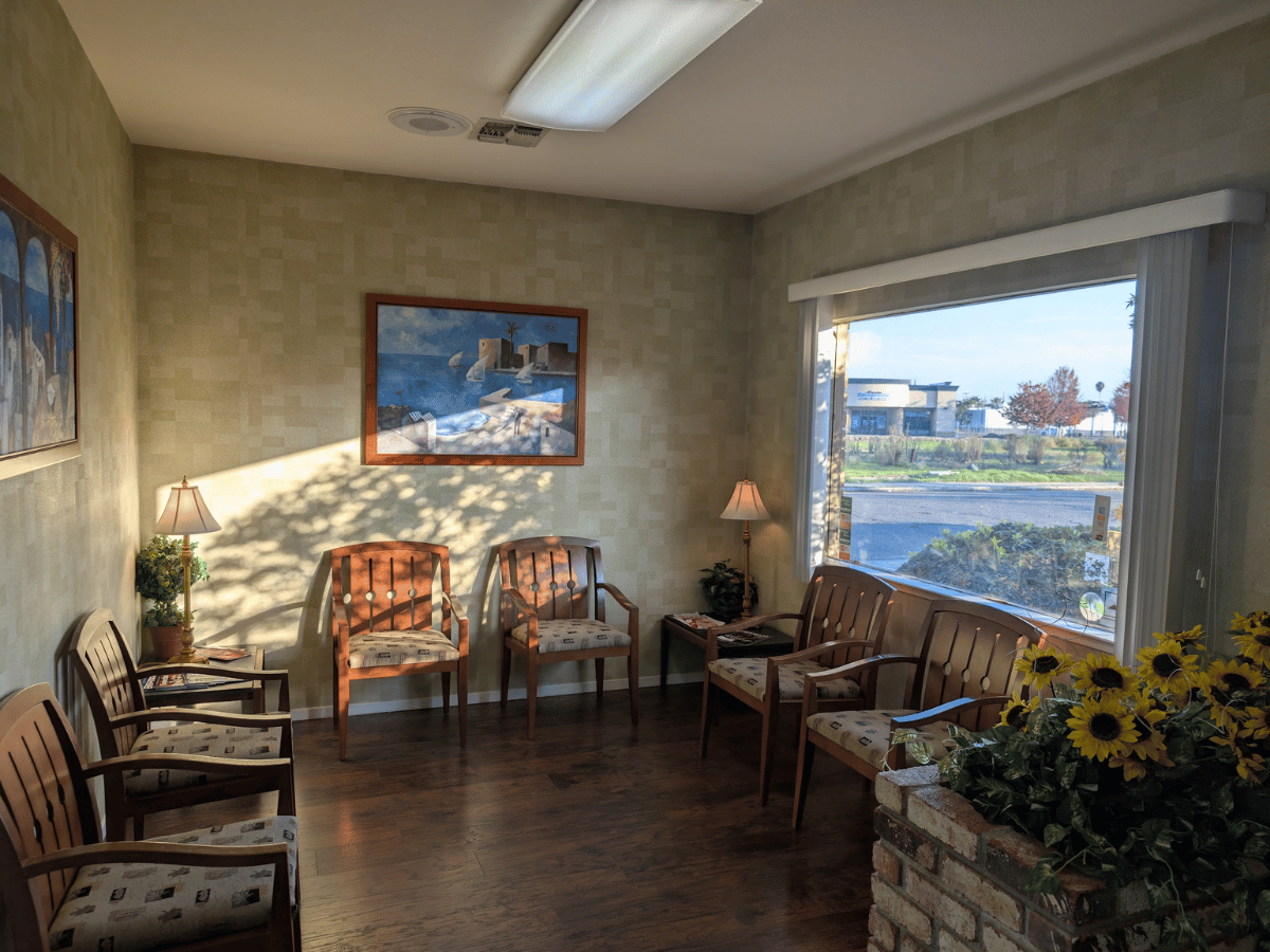 Comfortable waiting room with wooden chairs and sunflowers